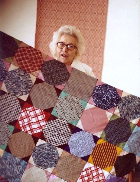 Caroline shows off a quilt, 1981